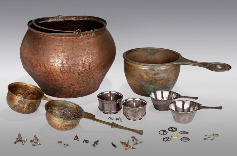 Sieben Gefäße unterschiedlicher Größe und Form sowie ein Sieb und verschiedene kleinteilige Funde aus einem germanischen Fürstengrab.